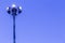 Spotlights tower high voltage in sport stadium on blue sky background