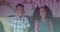 Spots of light against portrait of african american brother and sister smiling sitting on the couch