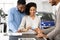 Spouses Giving Credit Card To Automobile Seller In Auto Showroom