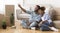 Spouses Making Selfie On Smartphone Sitting On Floor Indoor, Panorama