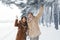 Spouses Shaking Branch Making Snowfall Having Fun In Snowy Forest