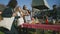 Spouses stand near grill at farmers market