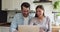 Spouses watching sport match on laptop celebrating favourite team win