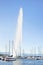 Spouting Geneva fountain with yachts on the foreground, Switzerland