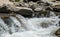 Spray and foam of a mountain river. The picturesque nature of the Rocky Mountains. Colorado, United States