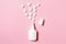 Spray for nose congestion treatment on pink background - cold, flu and medicine concept