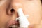 Spray for a nose in a girl`s nose, nose drops, gri n and colds, cannot breathe, nasal congestion