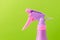 Spray nozzle on a bottle/purple spray nozzle on a bottle on a green background. Copy space