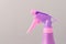 Spray nozzle on a bottle/purple spray nozzle on a bottle on a grey background. Copy space