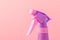 Spray nozzle on a bottle/purple spray nozzle on a bottle on a pink background. Copy space
