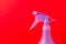 Spray nozzle on a bottle/purple spray nozzle on a bottle on a red background