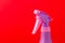 Spray nozzle on a bottle/purple spray nozzle on a bottle on a red background