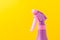 Spray nozzle on a bottle/purple spray nozzle on a bottle on a yellow background. Copy space