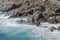 Spray of a strong surf on a rocky shore