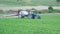 Spraying agricultural plants with fertilizers or chemicals on industrial plantings.