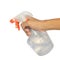 Spraying a cloth with laundry detergent in spray bottle