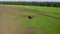 Spraying tractor riding on green field in countryside