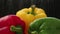 Spraying water sprinkles and drops on fresh colorful bell peppers  close up