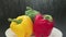Spraying water sprinkles and drops on fresh colorful bell peppers on plate