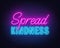 Spread Kindness neon lettering on brick wall background.