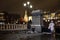 Spread trash around the trash can in Manezhnaya square with Moscow Kremlin on background.