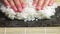 Spreading Cooked Sushi Rice On A Seaweed Wrap - Sushi Making - close up, slow motion.Sushi Chef Spreading Japanese Sushi