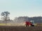 Spreading lime on a plowed field