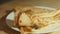 Spreading lump fish black roe with taramasalata on blinis. Isolated closeup macro