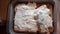 Spreading mascarpone cream evenly on savoiardi biscuits during preparation of tiramisu, top view, delicious italian prep in the