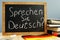 Sprechen Sie Deutsch written on a blackboard. Learn German.