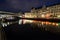 Spree Canal in Berlin night effect from lights over bridge on Friedrichstrasse, Germany.