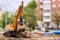 Sprig of a blossoming apple tree on a blurred background of a construction site