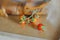 Sprig of cherry tomatoes on a wooden table in the teeth of a decorative wooden crocodile