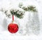 Sprig of christmas tree spruce with of hanging ball in snow in of winter fir forest during snowfall with space for text