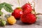 Sprig of yellow raspberries and red ripe strawberries are not grey wooden table