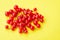 Sprigs of red currant on yellow background