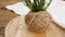 Sprigs of rosemary and skeins of jute rope on a wooden board for cutting