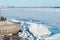 Spring on the Amur River. Ice drift. Sunny day. Pier city embankment. A large pile of ice blocks. River port. Side view