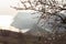 Spring atmospheric landscape in neutral shades. Panoramic view of the Cembalo fortress through the almond blossom