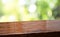 Spring background.Empty diagonal brown wooden table with blur tree in garden boekh background,banner mockup template for display