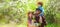 Spring banner with happy family. Cheerful family on picnic in a park. Family Farmers working in tree garden at spring