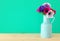 spring bouquet of colorful anemones in the vase over wooden table