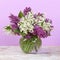 Spring bouquet. Lily of the valley and lilac in a vase