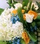 Spring bouquet of mixed colorful flowers. Flowers bouquet including white tulips, white hydrangea, yellow roses blue gypsophila