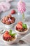 Spring Breakfast with granola and fresh strawberries and lychee and flowers on wooden background