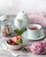 Spring Breakfast with granola and fresh strawberries and lychee and flowers on wooden background