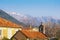 Spring. Cherry blossoms, red tiled roofs and small ancient church against snow-capped mountains. Montenegro