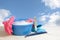 Spring cleaning, blue plastic bowl with soap foam, pink rubber g