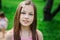 Spring closeup outdoor portrait of adorable 11 years old preteen kid girl