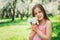Spring closeup outdoor portrait of adorable 11 years old preteen kid girl